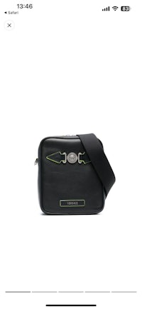 an image of a black cross body bag with green trim